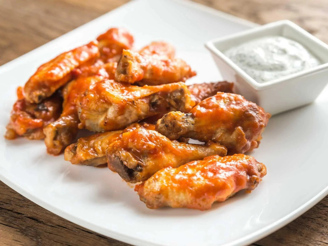 Buffalo chicken wings with ranch dip on the side.