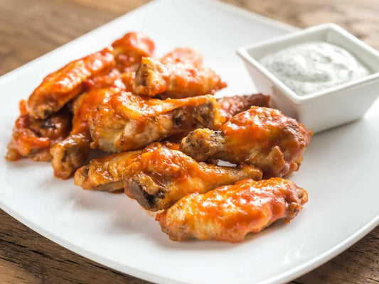 Buffalo chicken wings with ranch dip on the side.