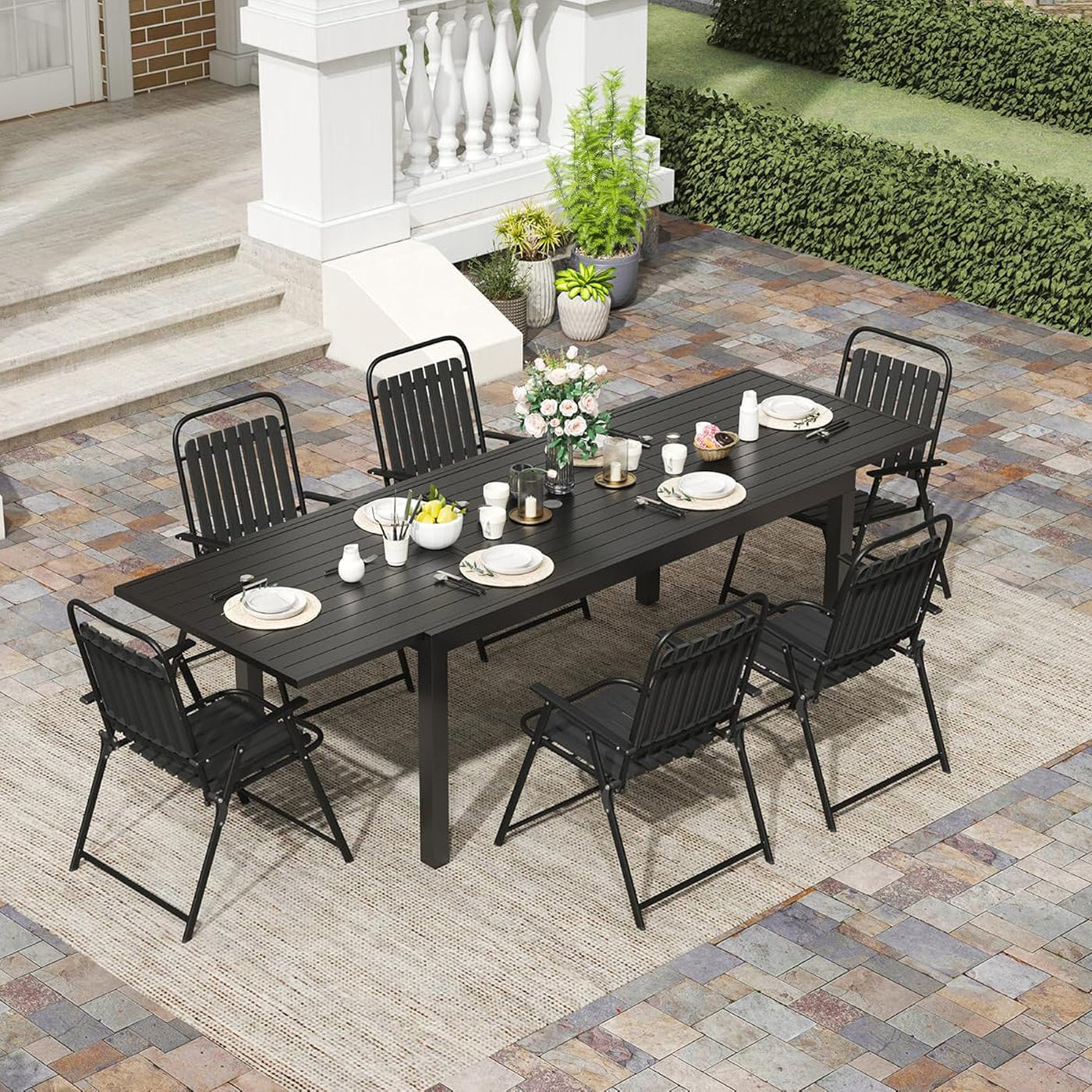 Revamp your patio dining area with the Pizzello Aluminum Extendable Table set. It includes a sleek black table, eight chairs, and matching tableware.