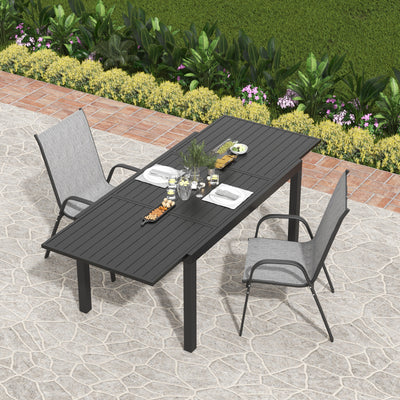 Outdoor dining setup with patio furniture, plants, snacks on a stone-paved surface against a lush garden—affordable at Walmart.